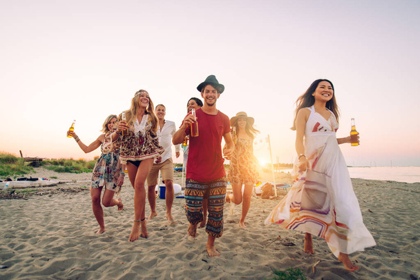 Happy group of friends celebrating and having fun on the beach - Young people on summer holiday - Фото, изображение