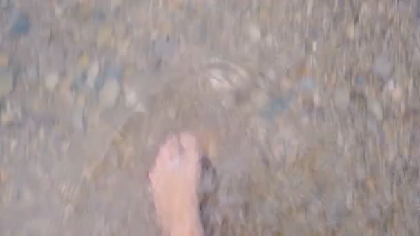 feet of woman in the sea waves, top view - Felvétel, videó