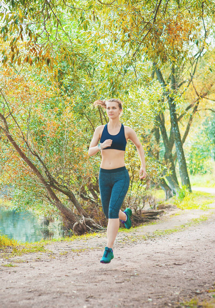 Active beautiful woman running in the park outdoor. Healthy lifestyle - Fotó, kép