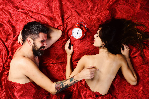 Couple in love on red sheets. Man and woman - Fotografie, Obrázek