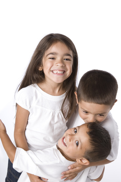 Smiling hispanic siblings hugging - Фото, зображення