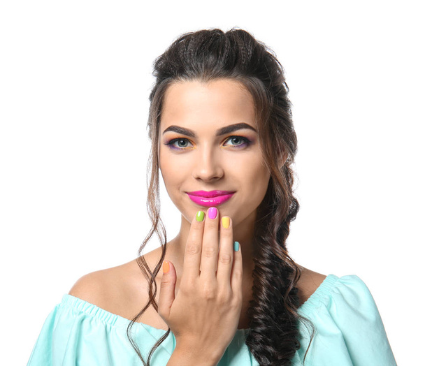 Beautiful young woman with colorful manicure on white background - Foto, imagen