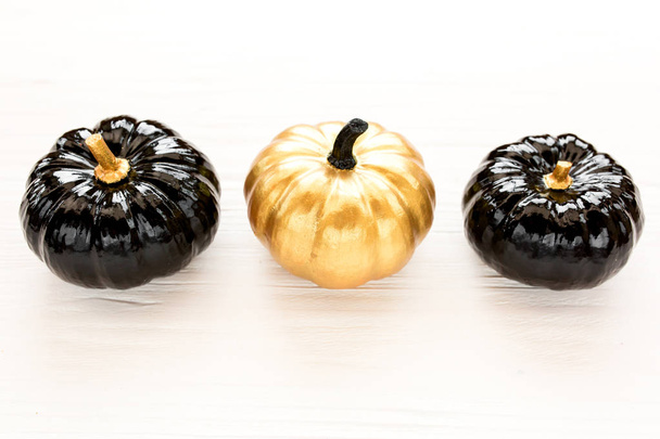 Decorative pumpkin black and gold Halloween isolated on white background. Flat lay, top view. - Foto, imagen