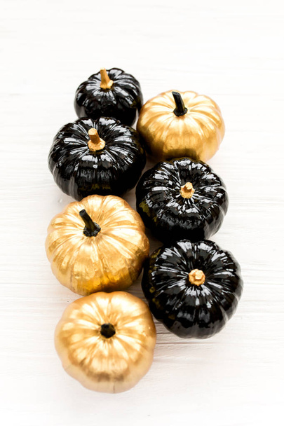 Decorative pumpkin black and gold Halloween isolated on white background. Flat lay, top view. - Photo, image