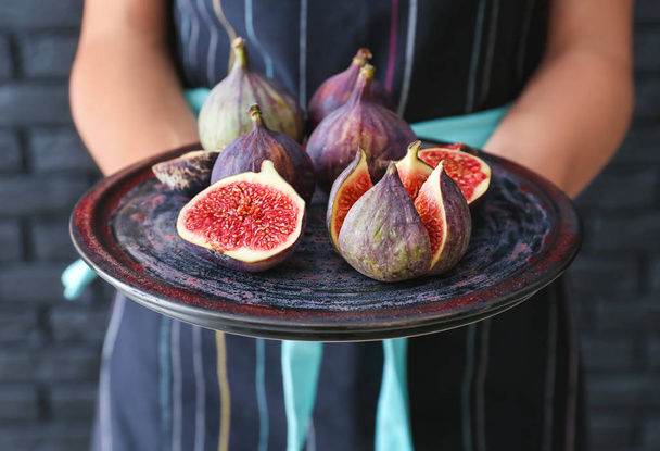 Woman holding plate with fresh ripe figs, closeup - Photo, Image