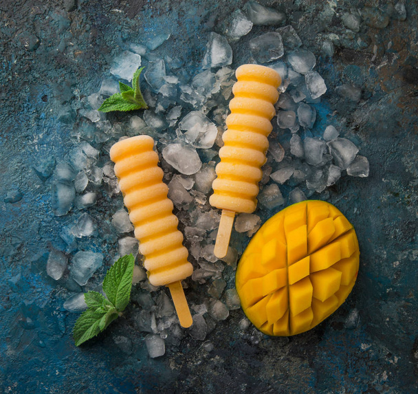 homemade mango popsicles, blue background, top view, square image - Foto, immagini