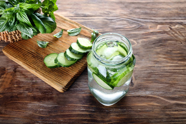 Jar of cucumber infused water on wooden table - Photo, Image
