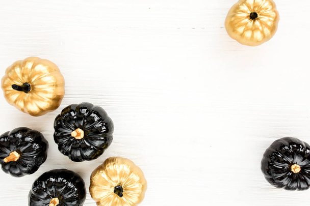 Decorative pumpkin black and gold Halloween isolated on white background. Flat lay, top view. - Foto, afbeelding