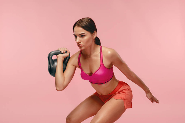 Workout. Woman Training With Dumbbell On Pink Background - Zdjęcie, obraz