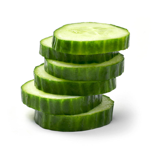 Fresh cucumber slices, isolated on white background. Close up shot of cucumber, arrangement or pile. - Photo, Image