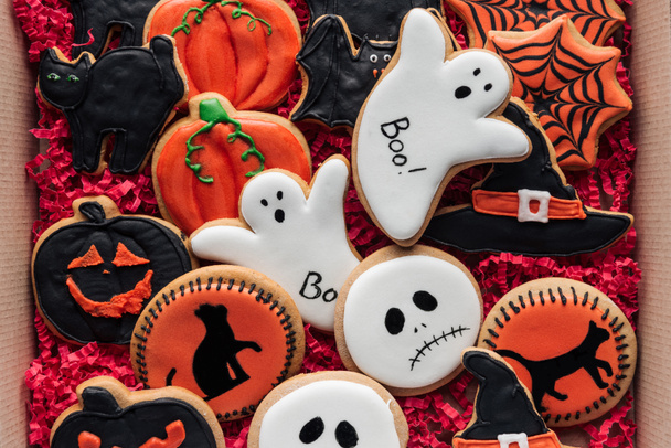 top view of cardboard box with homemade spooky halloween cookies  - Photo, Image
