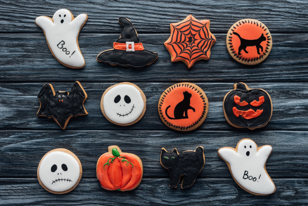 elevated view of composition with sppoky halloween cookies on wooden table  - Фото, зображення