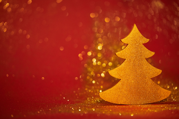 golden glittering decorative christmas tree on red background - Foto, imagen