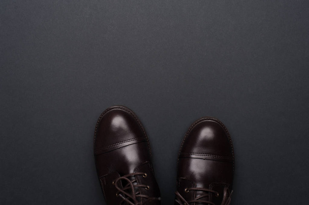Dark brown man shoes on grey background. - Valokuva, kuva