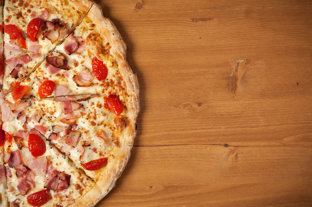 Fresh Italian pizza on wooden desk - 写真・画像