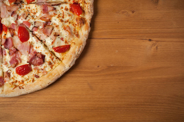 Fresh Italian pizza on wooden desk - Fotó, kép