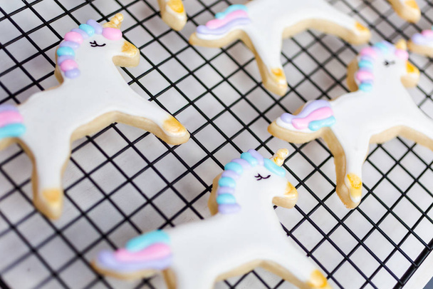 Decorating unicorn themed sugar cookies with royal icing. - Fotoğraf, Görsel