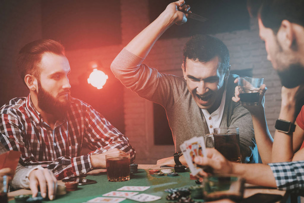 Young Friends Playing Poker on Party at Home. Playing Games. Indoor Fun. Young Girl. Young Guy. Sitting at Table. Party with Friends. Indoor Activities Concept. Gambling. Card Games. - Photo, Image