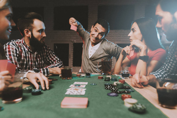 Young Friends Playing Poker on Party at Home. Playing Games. Indoor Fun. Young Girl. Young Guy. Sitting at Table. Party with Friends. Indoor Activities Concept. Gambling. Card Games. - Foto, Bild