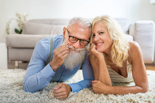 Senior couple in the 60's having fun at home - Cheerful married couple portrait, concepts about senority and relationship - Фото, изображение
