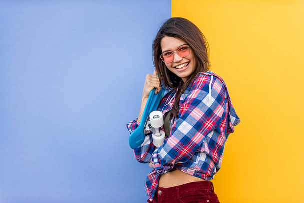 Portrait of stylish pretty girl on colored background - Happy woman with urban styled attire, concepts about lifestyle and youth - Фото, изображение