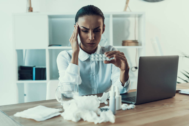 Young Sick Woman in White Shirt Sitting in Office.Healthcare Concept. Modern Office. Sick Worker. Healthcare in Office. Wooden Table. Digital Device. Laptop on Desk. Young Woman in Office. - Foto, Imagem