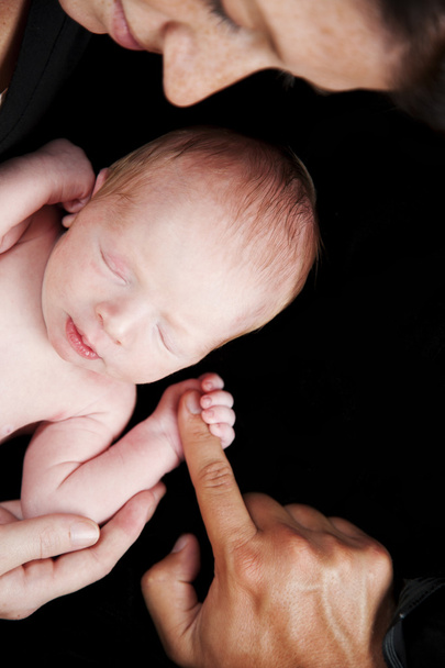 Newborn baby grasping finger - Фото, изображение