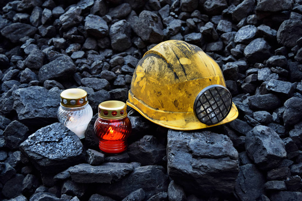 Vigil light, candle with mining helmet on cheap of coal after the fatal accident in the mine - Photo, Image