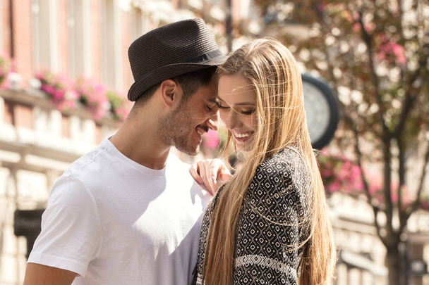 Beautiful young couple dating outdoors. Happy blonde attractive girl with handsome man. - 写真・画像