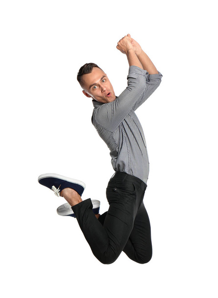 Young man in casual clothes jumping on white background - Foto, Bild