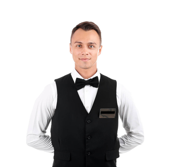 Portrait of young waiter in uniform on white background - Photo, image
