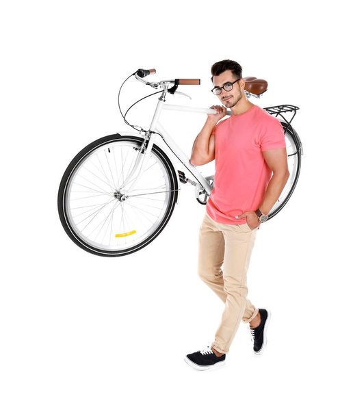 Handsome young hipster man with bicycle on white background - Foto, Imagem