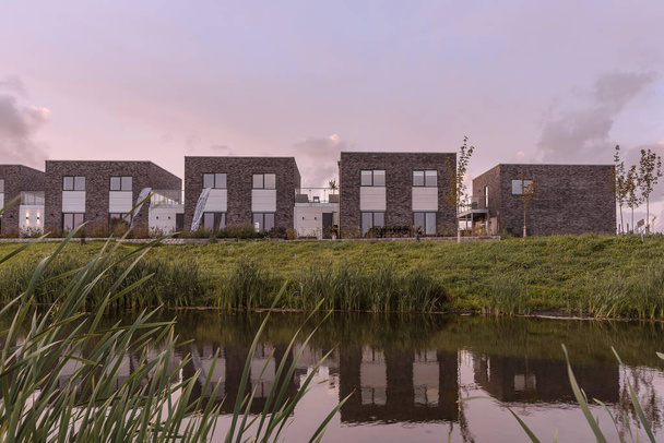 New modern villas on the bank of a man-made creek, Frederikssund, Denmark, September 12, 2018 - Fotó, kép