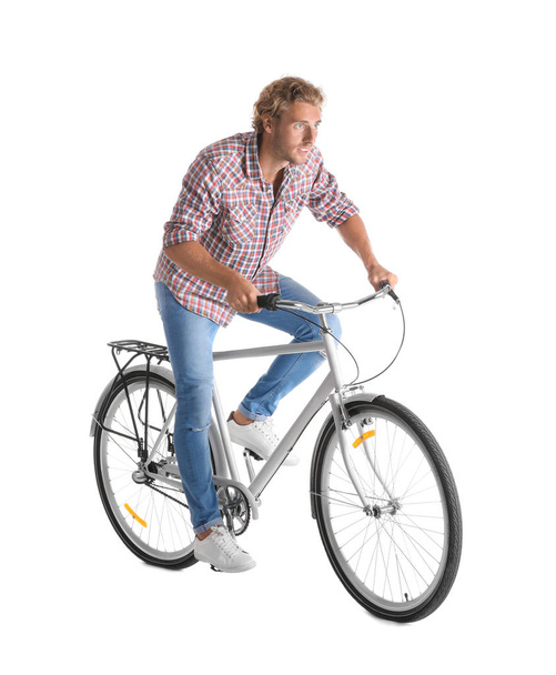 Handsome young man riding bicycle on white background - Φωτογραφία, εικόνα