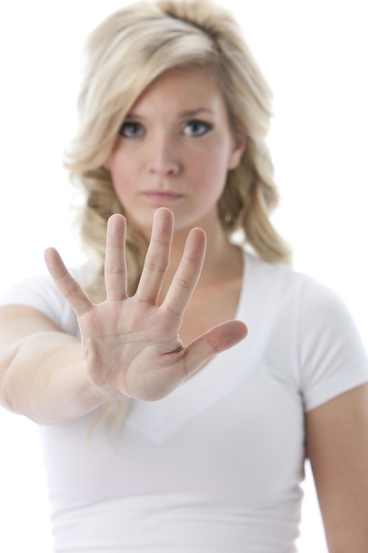 Young woman holding her hands up as a warning or to say stop - Foto, Imagen