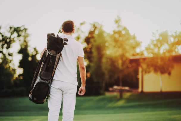 Young Man in White Clothes Playing Golf on Field. Relaxing in Golf Club. Sports in Summer. Outdoor Fun in Summer. Happy Young Man. Healthy Lifestyle Concept. Man it White Shirt. Green Grass. - Fotó, kép