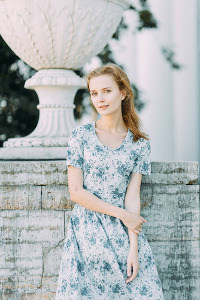 beautiful girl in the Park, in a summer dress and walking. Smiles and enjoys nature. St. Petersburg, Yelagin island - Photo, image