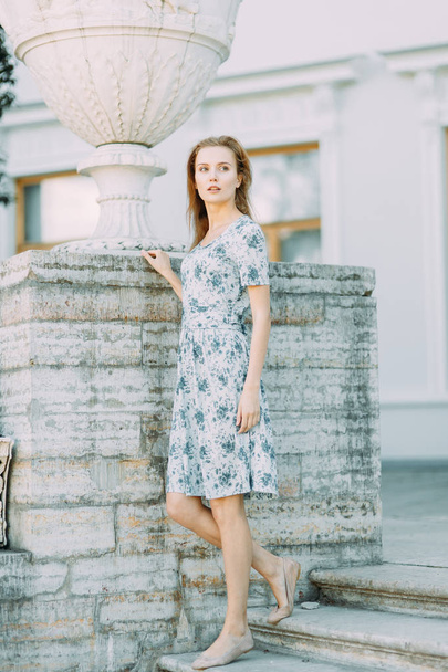 beautiful girl in the Park, in a summer dress and walking. Smiles and enjoys nature. St. Petersburg, Yelagin island - Фото, зображення