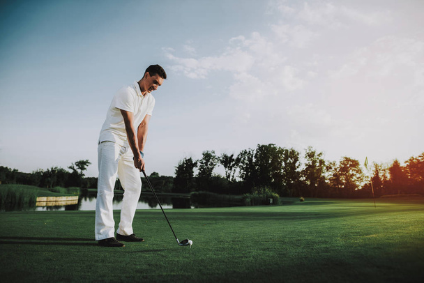 Young Man in White Clothes Playing Golf on Field. Relaxing in Golf Club. Sports in Summer. Outdoor Fun in Summer. Happy Young Man. Healthy Lifestyle Concept. Man it White Shirt. Green Grass. - Fotó, kép