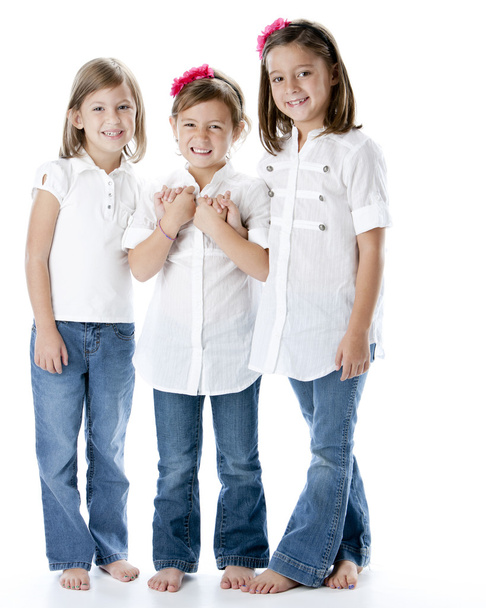 Full length image of three smiling little girls holding hands - Photo, Image