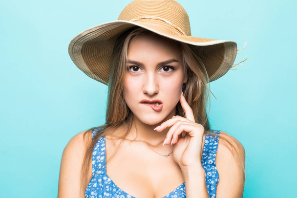 Face portrait of woman in straw hat on blue background - Fotó, kép