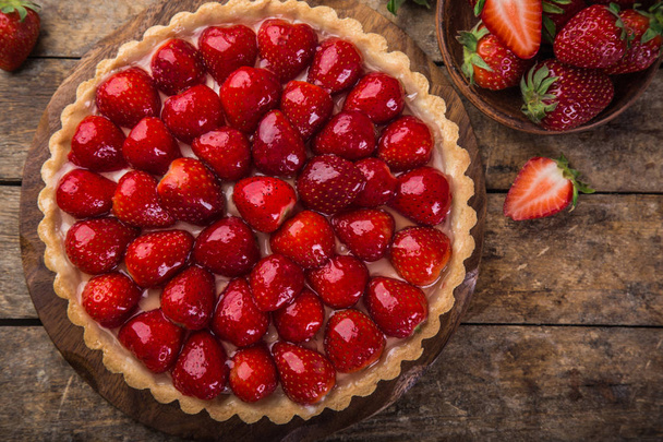 delicious strawberry tart on wooden background, top view - Fotoğraf, Görsel