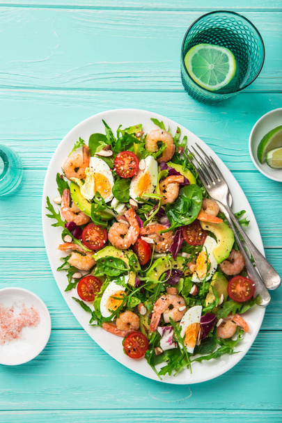 avocado, tomato, eggs and shrimps salad. Top view - Фото, изображение