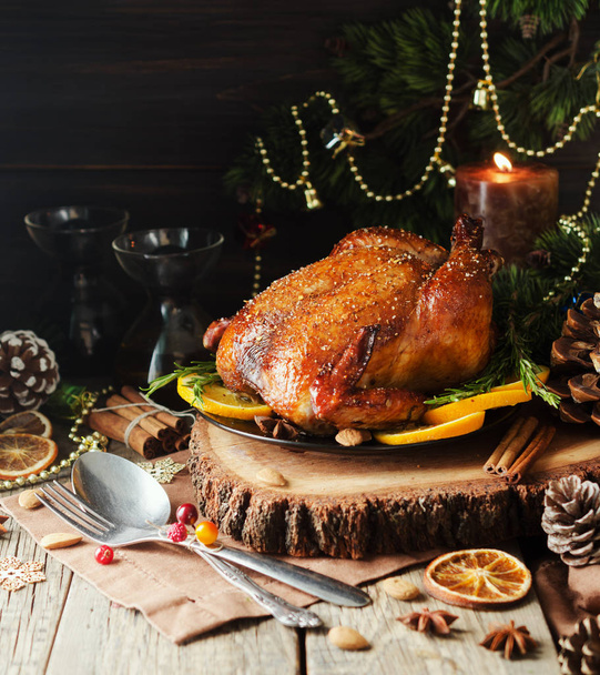 Roast chicken or turkey for Christmas Dinner and New Year with mulled wine and Christmas decorations, space for text, selective focus - 写真・画像