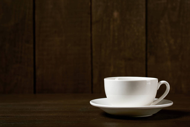 one classic coffee or tea cup on a dark wooden background - Fotoğraf, Görsel