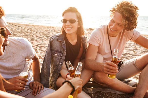 Group of happy young friends having fun time together at the beach, drinking beer, camping - Foto, Imagen