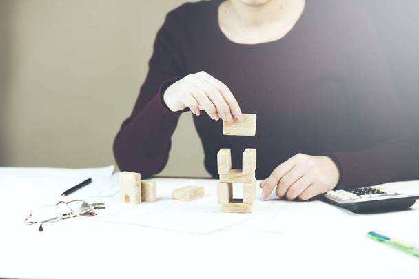 business woman  placing wooden block on a tower - Foto, immagini