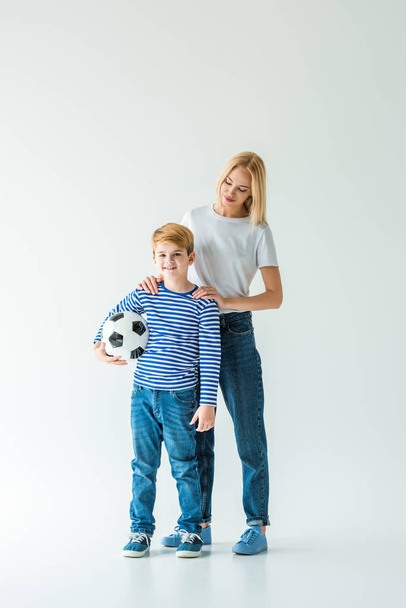 mother and son standing with football ball on white - Fotografie, Obrázek