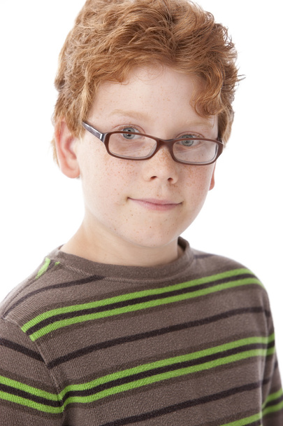 Caucasian smiling little real boy with red hair and glasses. - 写真・画像