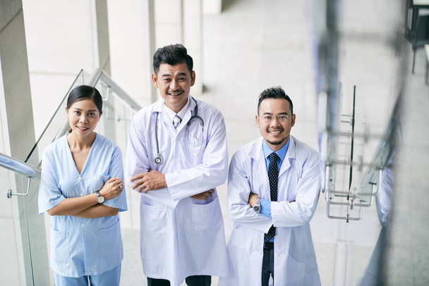 Portrait of joyful medical people standing with arms crossed - Zdjęcie, obraz